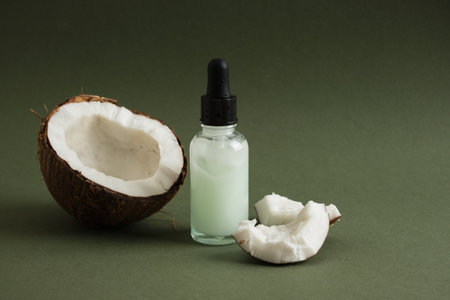 Natural organic coconut oil or serum in amber glass dropper bottle, natural cosmetic with coconut extractの写真素材