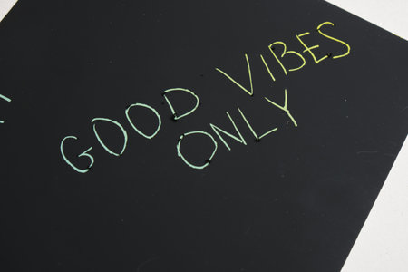 colored motivational slogans are scratched on on a black engraving board GOOD VIBES ONLY