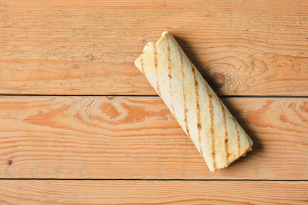 stuffed pita bread, sliced chicken roll with vegetables, pita with sauces and meat on a wooden background table copy space mockupの写真素材
