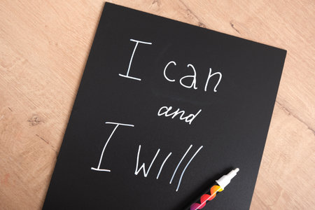 I can I will inscription on black matte plastic board, motivational slogan concept, creative text with chalk marker on boardの写真素材