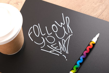 follow your heart inscription on black matte plastic board, motivational slogan concept, creative...