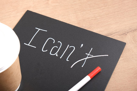 I can I can't sign on black matte plastic board, motivational slogan concept, creative text with...