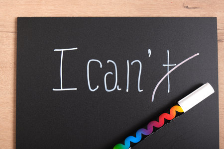 I can I can't sign on black matte plastic board, motivational slogan concept, creative text with chalk marker on boardの写真素材