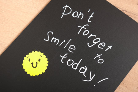 don't forget to smile today text chalk marker on black board yellow smile motivation for the dayの写真素材