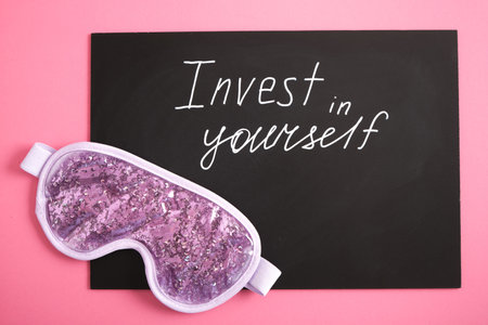 white chalk marker writing on black board, invest in yourself, top view copy space, sleep mask, take care of your healthy sleep, self loveの写真素材