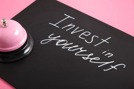 white chalk marker writing on black board, invest in yourself, top view copy space, self care time,...
