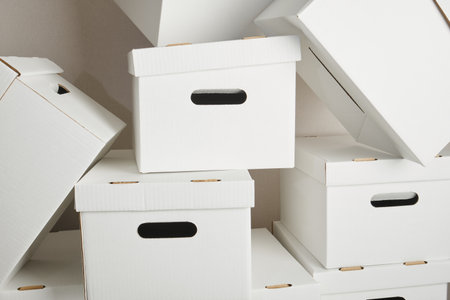 pile of white cardboard boxes with slots for holding, storage boxesの写真素材