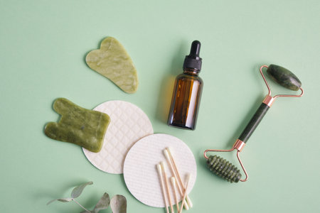 Facial massage set made of natural materials and components, natural cosmetics in amber glass and facial massagers made of natural stoneの写真素材