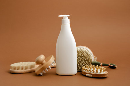 various products for body and face massage and white mock up bottle with dispenser on brown backgroundの写真素材