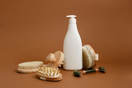 various products for body and face massage and white mock up bottle with dispenser on brown backgroundの写真素材