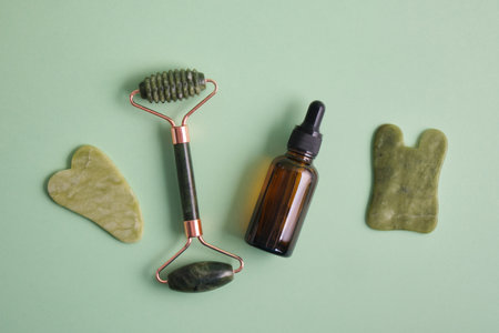 Facial massage set made of natural materials and components, natural cosmetics in amber glass and facial massagers made of natural stoneの写真素材