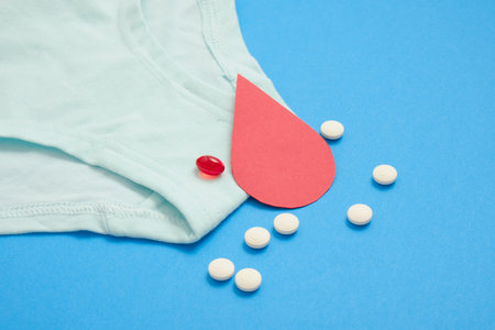 womens comfortable panties small size, blood drop paper and medical pills, concept of womens health, contraception and PMS first menstruationの写真素材
