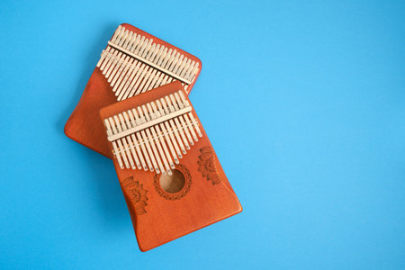 wooden kalimba on blue background, traditional African musical instrument, meditation instrument.の写真素材