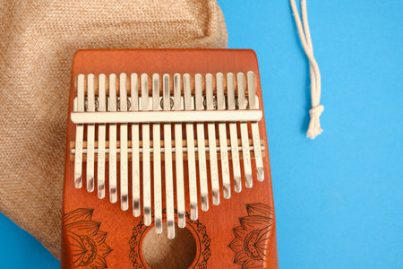 wooden kalimba on blue background, traditional African musical instrument, meditation instrument.の写真素材