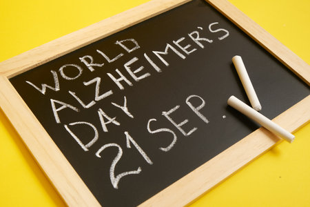chalk board with the inscription September 21 World Alzheimer's Day yellow backgroundの写真素材