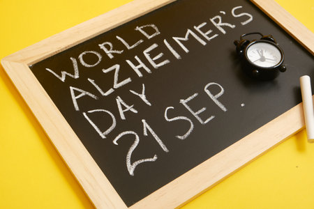 chalk inscription september 21 world alzheimer day, concept of cognitive decline of the brain yellow backgroundの写真素材
