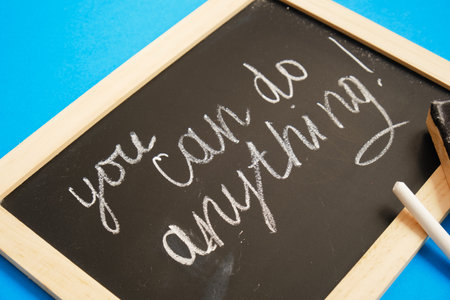 chalk writing on daughter "you can do anything"の写真素材
