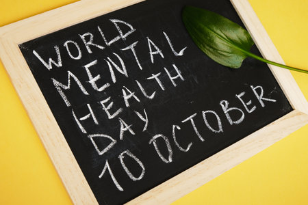 chalk board inscription world mental health day on yellow background, emotional health concept, October 10の写真素材