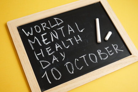 chalk board inscription world mental health day on yellow background, emotional health concept, October 10の写真素材
