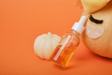 Autumn cute pumpkin with patches and cosmetic containers, autumn self-care conceptの写真素材