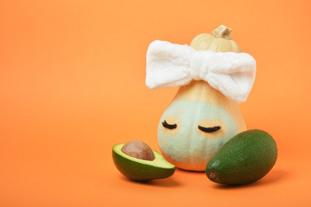 Pumpkin and avocado on an orange background, copy space, mock upの写真素材