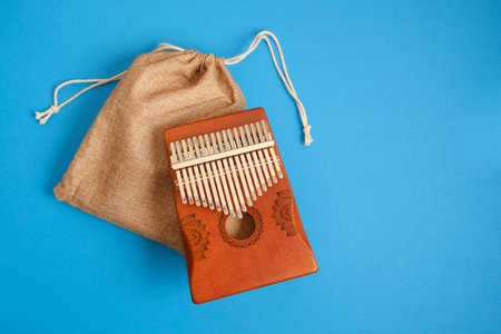 wooden kalimba on blue background, traditional African musical instrument, meditation instrument. 17 notesの写真素材