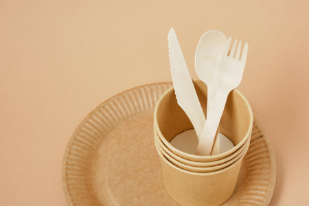 Eco paper plate fork on beige background no plastic, recyclable tablewareの写真素材