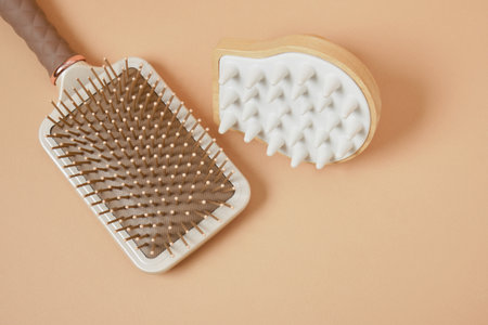 Hair comb and scalp massager on beige backgroundの写真素材