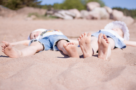  Summer vacation. Little children boy and girl lie on the  sand beach. Travel, holiday and adventure conceptの写真素材
