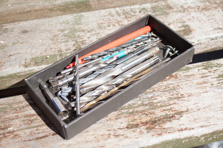 View of the drill bits. Working tools on wooden background.