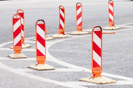 Road work signs in city. Orange traffic cones in the middle of the street. Traffic safety  construction roadworkの写真素材