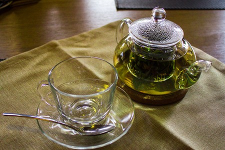 Beverages, good morning and breakfast concept - empty tea cup and teapot on the tableの写真素材
