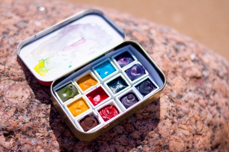 creation, drawing and freedom concept - Artistic equipment watercolors paintings on rock background...