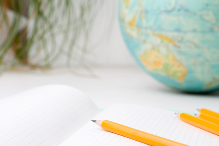 Back to school and education concept - school office supplies pencils, paper, notebook and globe on boke background. for educational new academic year begin or study term start.の写真素材