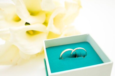 wedding symbols two golden rings with callas white flowers - love, family, celebration, ceremony conceptの写真素材