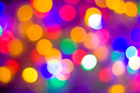 christmas and new year concept - Defocused abstract multicolored bokeh lights background. Blue, purple, green, orange colors.の写真素材