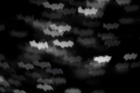 defocused white bats silhouette ghosts on black for halloween background - holidays, decoration and party conceptの写真素材