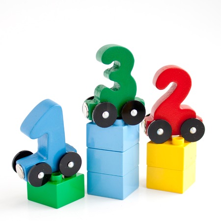 wooden numbers 0,1,2 letters train alphabet . Bright colors of red yellow green on a white...