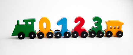wooden numbers 0,1,2,3 letters train alphabet . Bright colors of red yellow green on a white...
