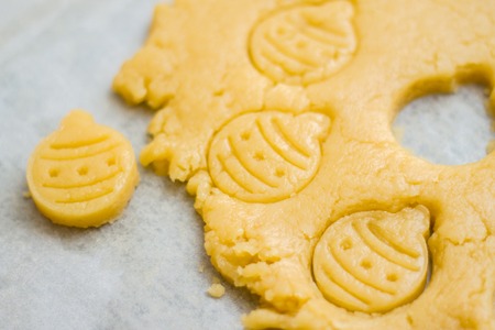 Raw dough for christmas cookies for children, making gingerbread in form of ball close-up. New year...