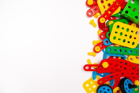 Frame for text. Top view of multicolor kids toy construction blocks bricks on white background....