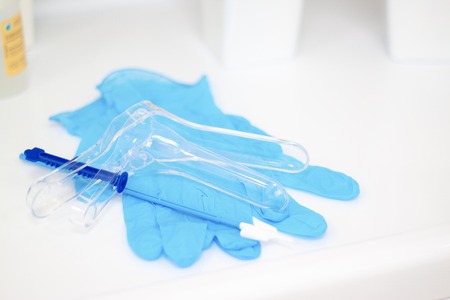 Medicine instrument vaginal speculum, vaginoscope, gloves gynecologist doctor and other medical equipment in clinic hospital. Gynecological woman health, newborn and pregnancy concept. copyspaceの写真素材