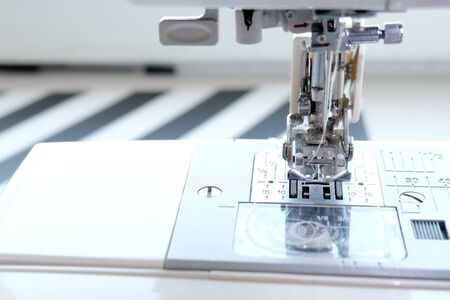 Close up sewing machine at tailor workplace. Sew process. - needlework, craft, sewing and tailoring concept.の写真素材