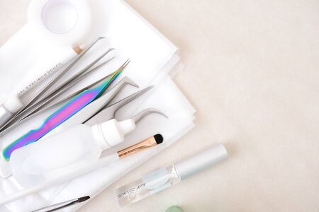 Eyelash Extension Procedure background. tools. glue, tweezers, brushes. Copyspace for text - Beauty salon, fashion and woman make up concept.の写真素材