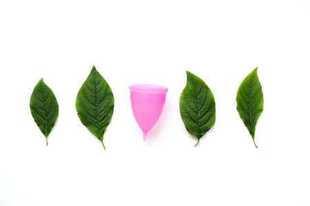 Reusable menstrual cup and tampon on pink background, Concept female intimate hygiene period products and zero waste. Flat lay, minimalism, top view. copyspace.の写真素材