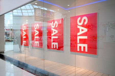 Season sale, black friday and shopping concept. Four Sale signs on red stands in shop store - ST. PETERSBURG, RUSSIA - jul 17, 2019のeditorial素材