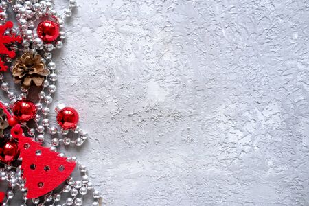 Christmas composition frame for text. Red decorations on grey background. Flat lay, top view - greeting card template christmas and New Year. copyspaceの写真素材