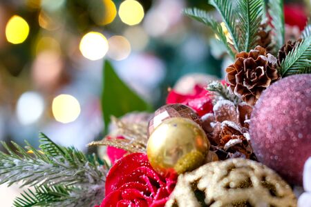 New Year card with Christmas tree, red rose, gold ribbon and fir cones - holidays, winter and celebration concept. Place for text.の写真素材