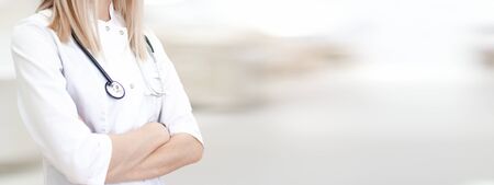 Medical wide banner with copyspace for text. Cropped caucasian woman doctor in white uniform. Blurred clinic on background. Healthcare, pharmacology conceptの写真素材