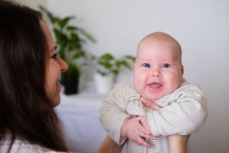 Happy baby. Little cutest chubby caucasian white infant child looking and smiling at camera on...